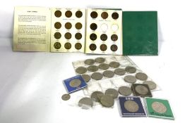 A box containing a large assortment of coinage, mainly UK denominations, including Royal