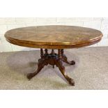 A Victorian walnut and inlaid centre table, circa 1880, with a moulded and marquetry tilt top set on