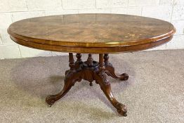 A Victorian walnut and inlaid centre table, circa 1880, with a moulded and marquetry tilt top set on