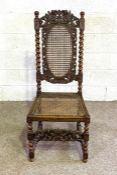 A Carolean style caned oak side chair, late 19th century, with twist column supports and carved