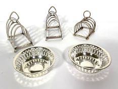 A pair of Edwardian silver toast racks, Sheffield 1920; together with another smaller toast rack;