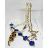 An assortment of costume jewellery, including a 'ruby' style necklace, assorted brooches, beads,