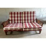 A modern teak framed adjustable two seat settee, with caned seat and red tartan cushions, 157cm