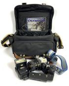 A vintage Olympus OM10 camera, with a Miranda Macro lens, assorted filter and components, in a