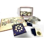 An assortment of collectible coins, including commemorative £5 coins, assorted pennies, crowns