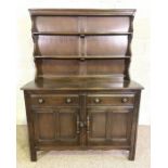 A modern Ercol style beech wood dresser, with a rack over a base with two drawers and two cabinet