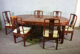 A Chinese hongmu or hardwood dining suite, including an extending oval dining table, and a set of