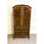 A vintage walnut veneered and dark varnished reproduction linen press, with two cabinet doors and