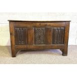 A 17th century (and later) oak coffer, the rectangular planked top (replaced), over a carved a