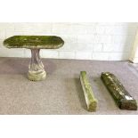 A composition stone garden table, with oblong top on a twist columnar support, 77cm high, 110cm