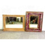 Two large wall mirrors; one with a cushioned frame and painted with leaves; the other a stripped