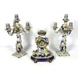 A Meissen style ceramic clock garniture, 20th century, with a pair of four light candelabra, the