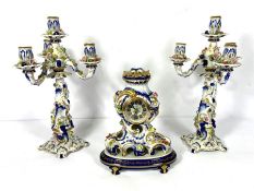 A Meissen style ceramic clock garniture, 20th century, with a pair of four light candelabra, the
