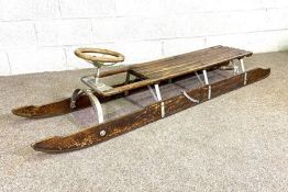 A vintage bobsled (or steerable toboggan), circa 1930, the long two person ash and iron sledge