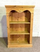 A small pine open bookcase, with serpentine frieze and two fixed shelves, 122cm high, 77cm wide,