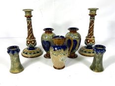 A selection of Doulton Lambeth stoneware, including a fine pair of candlesticks, with relief