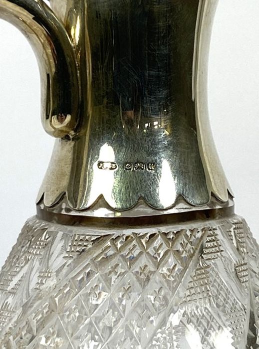 A silver mounted claret jug, hallmarked Birmingham 1919, with a pouring spout, hinged lid and scroll - Image 6 of 7