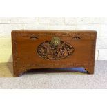 A Chinese style camphor carved chest, the top with carved relief panel depicting travellers