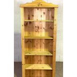 A narrow and tall pine open bookcase, modern, with reeded sides