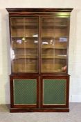 A large George III style simulated rosewood bookcase, with an moulded cornice over two glazed doors,