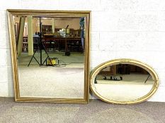 A large gilt moulded rectangular wall mirror, with beaded mouldings; together with an oval