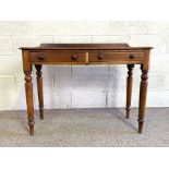 A Victorian two drawer side table, with rounded rectangular top and set on four ring turned and