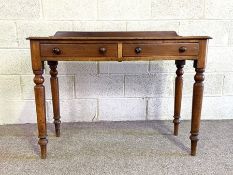 A Victorian two drawer side table, with rounded rectangular top and set on four ring turned and