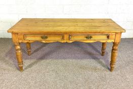 An Edwardian kitchen or refectory table, with planked top and two drawers, the reverse with a