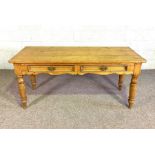An Edwardian kitchen or refectory table, with planked top and two drawers, the reverse with a
