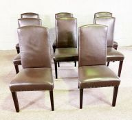 A set of eight modern brown leathered dining chairs chairs, with high arched backs and nailed aprons