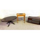 A small oval 'mahogany' varnished coffee table, modern; together with a small occasional table and a