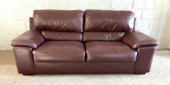 A modern dark leather two seater sofa; together with a dark leather armchair (2)