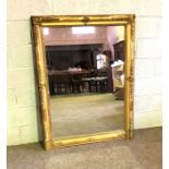 A large Continental composition gilt wall mirror, with a finely moulded rectangular frame and