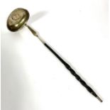 A Regency silver and baleen toddy ladle, the bowl inset with a silver 1811 token, with a twist