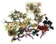 Two boxes of decorative glass flowers and ‘trees’, including a vine branch with bunch of amber glass