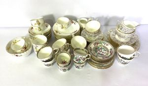 A large assortment of tea wares, including four part services, one with sprays of flowers, including