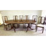 A George III style twin pillar mahogany dining table, modern, with one leaf; together with a set