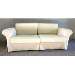 A pair of Ikea sofas, EKTORP type design, each with two large seat cushions and curved backs,