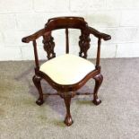 A Georgian style corner armchair, with scrolled arms and cabriole legs; 83cm high x 70cm wide