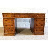 An oak twin pedestal desk, early 20th century, with inset writing surface over an arrangement of