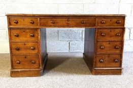 An oak twin pedestal desk, early 20th century, with inset writing surface over an arrangement of