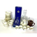 An assortment of ceramics and glassware including two part tea services, a cased decanter and a