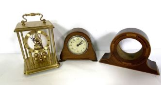 An assortment of clock parts, including enamel faces, together with various small clocks and a glass