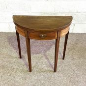 A George III style demi lune fold over tea table, with single drawer and tapered legs, 73cm high,