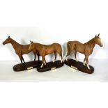 Three Royal Doulton models of famous racehorses, including Red Rum, DA20, The Minstrel and Grundy,