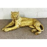 A large modern gold surfaced model of a reclining Tiger, 103cm long