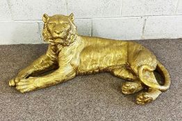 A large modern gold surfaced model of a reclining Tiger, 103cm long