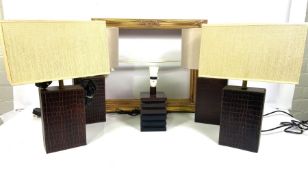A set of four leather based table lamps and shades, also a similar leather framed wall mirror, 118cm