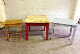 Three tables, including a stripped pine small kitchen table; a grey painted table and a small