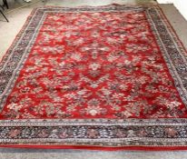 A modern wool Kashan rug, 20th century, with a burgundy field decorated with sprays of flowers